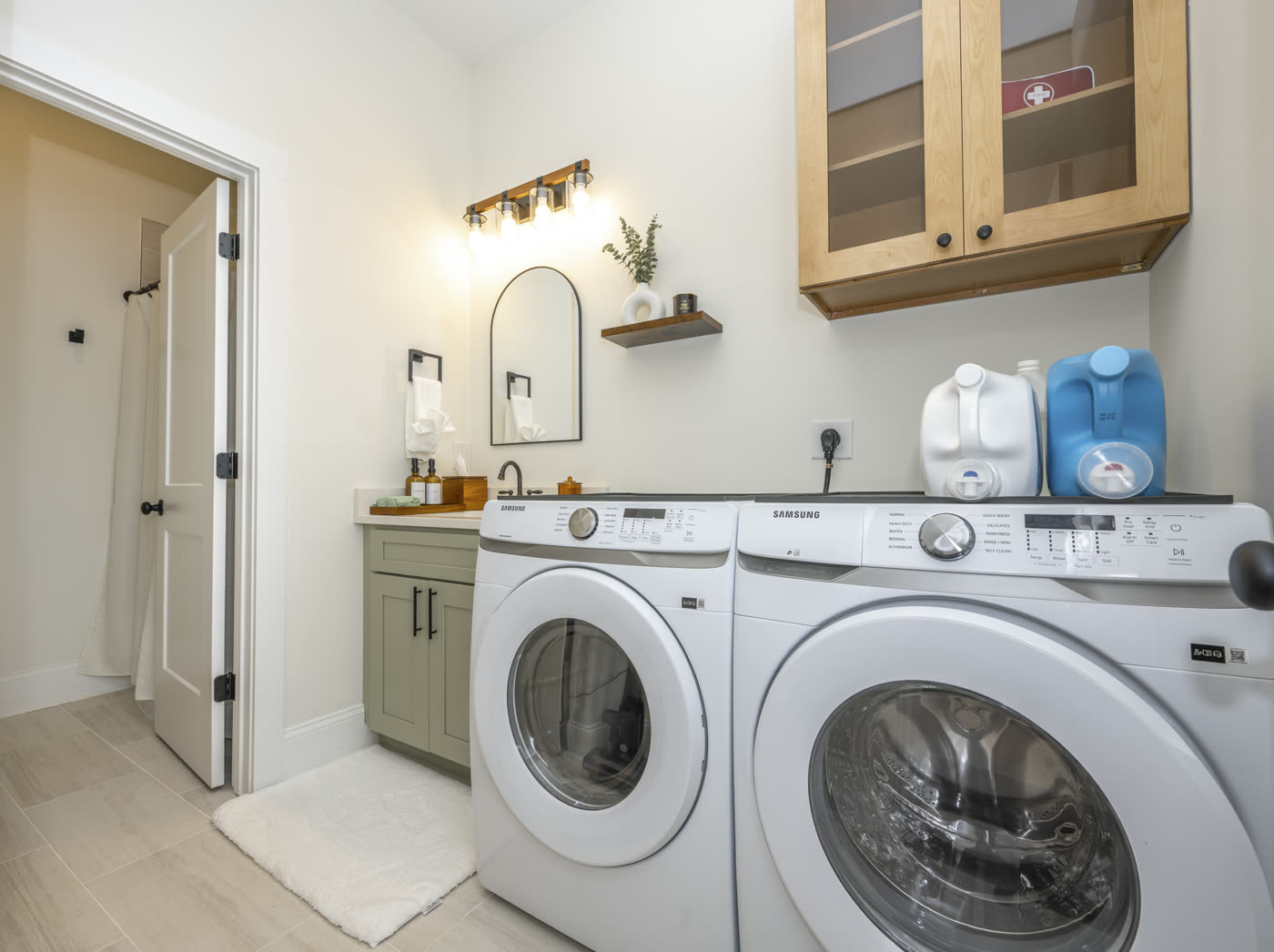 Laundry room with front-load washer and dryer and a small vanity sink