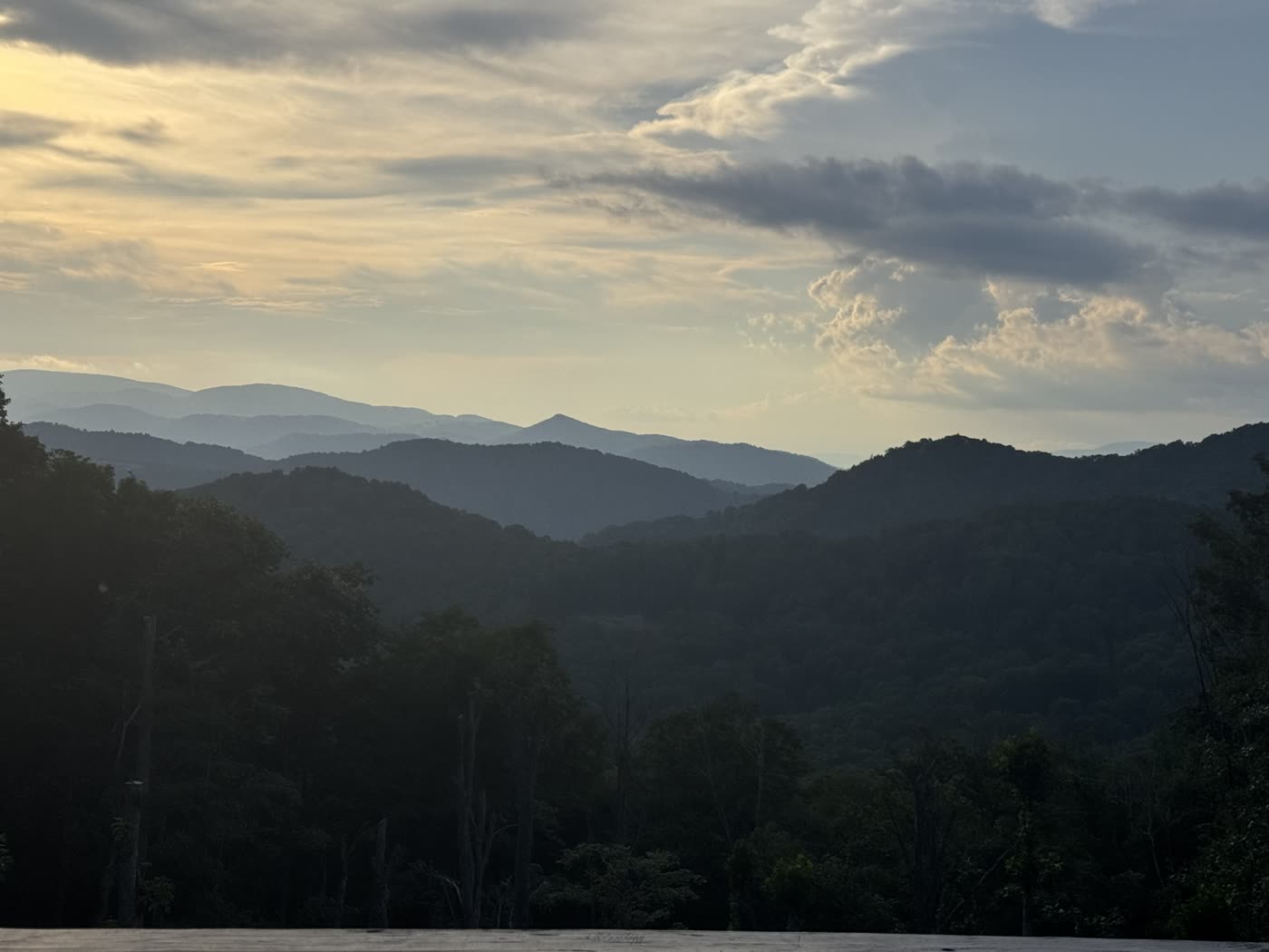 Vertical sunrise view over layered mountain ridgelines
